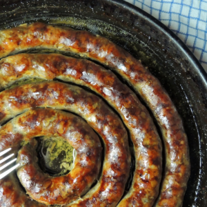 homemade sausage roll in a cast iron skillet, baked