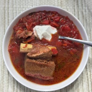 Classic Red Borsch in a bowl with short ribs.