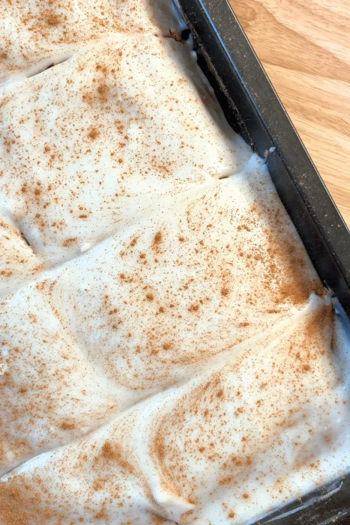 Sourdough pumpkin spice bars in a pan topped with creamy cream cheese frosting — soft, moist, and perfectly spiced fall dessert.