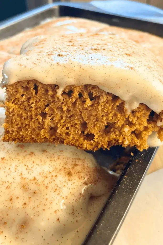 Close-up of frosted sourdough pumpkin spice bars showing soft, moist texture and creamy cream cheese frosting — perfect fall dessert.