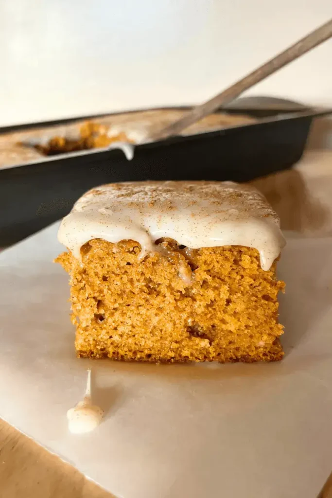 Close-up of frosted sourdough pumpkin spice bars showing soft, moist texture and creamy cream cheese frosting — perfect fall dessert.