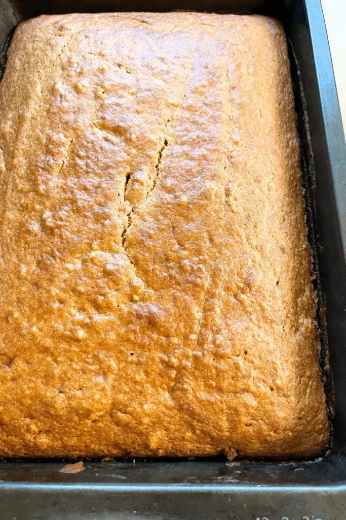 Baked sourdough pumpkin spice bars in a glass pan — golden, soft, and fluffy fall dessert ready for cream cheese frosting.