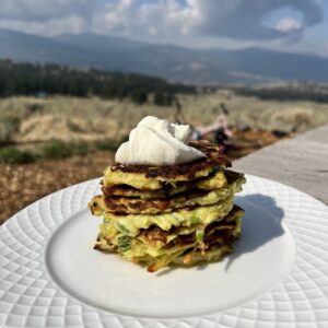 Sourdough zucchini fritters with sour cream on top.