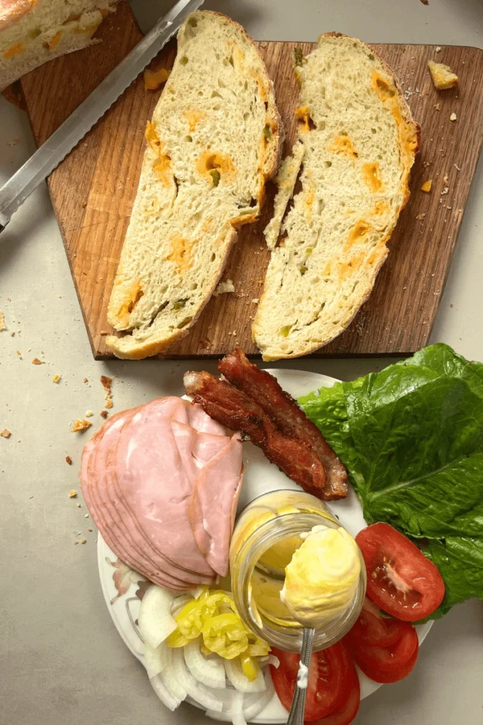 Sourdough Ham and Cheese Sandwich on a cutting board.
