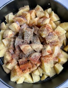 Potato with salt and pepper and paprika, oregano for oven roasted potatoes.