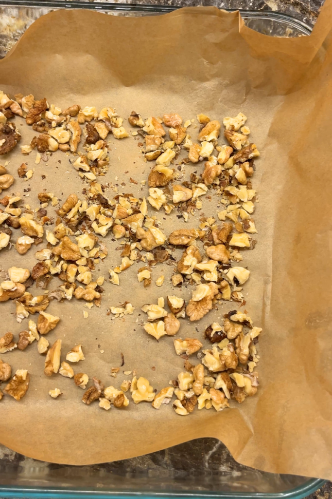 Nuts on a parchment paper for a Nutty Toffee Crunch.