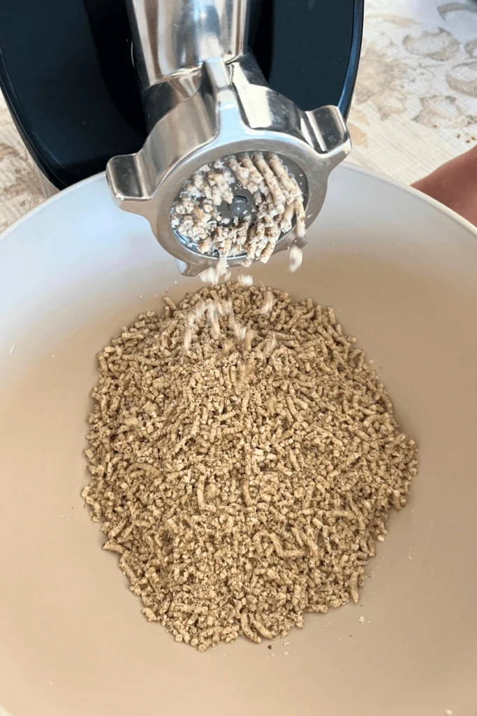 Grinding almonds in a meat grinder. 