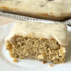 Sourdough Banana Snack Cake with Brown Butter Cream Cheese Frosting on a plate.