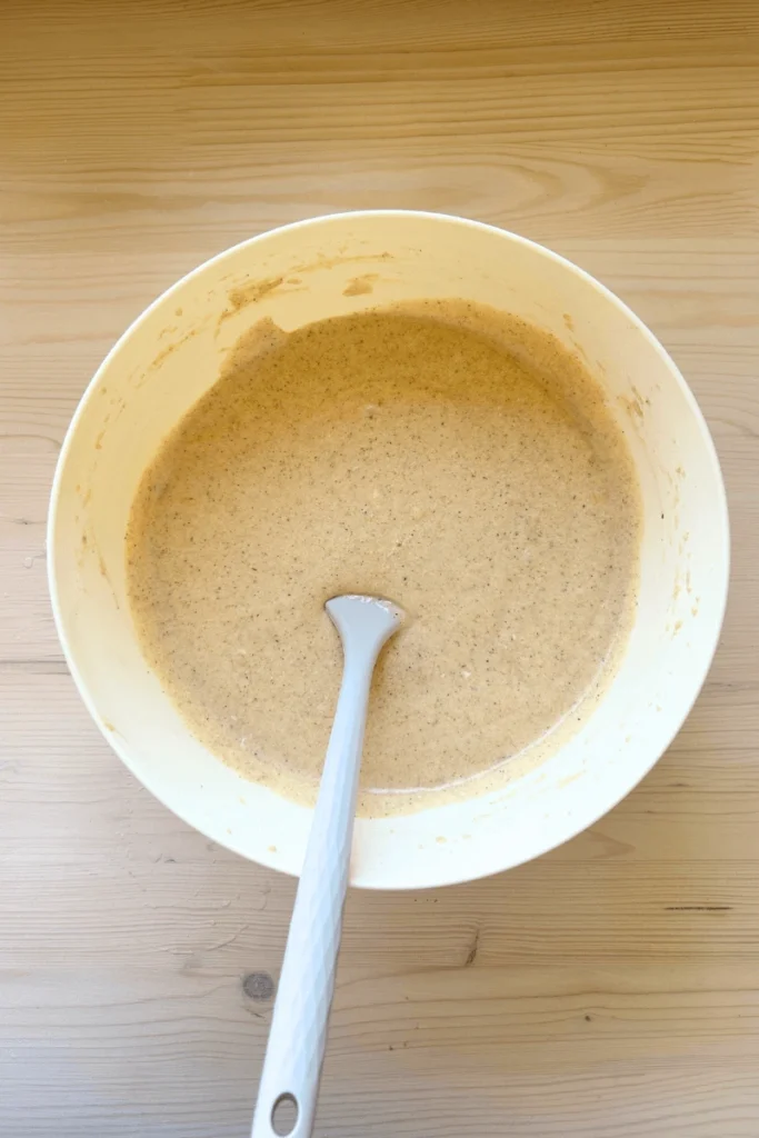 Snickerdoodle sourdough cake batter in a large mixing bowl. 