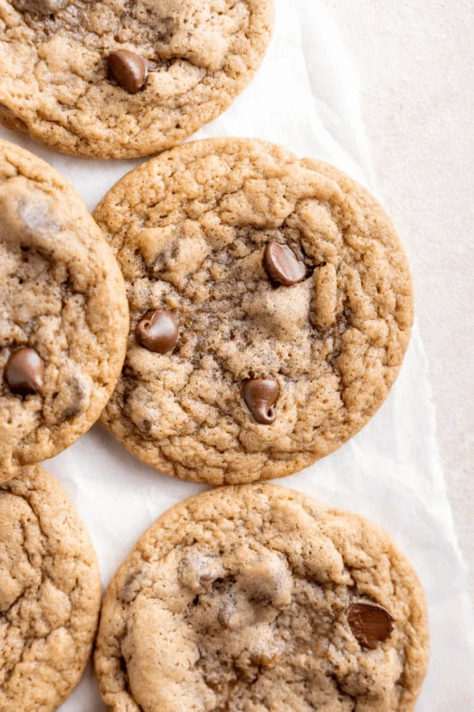 Sourdough Chocolate Chip Cookies on parchment paper. 