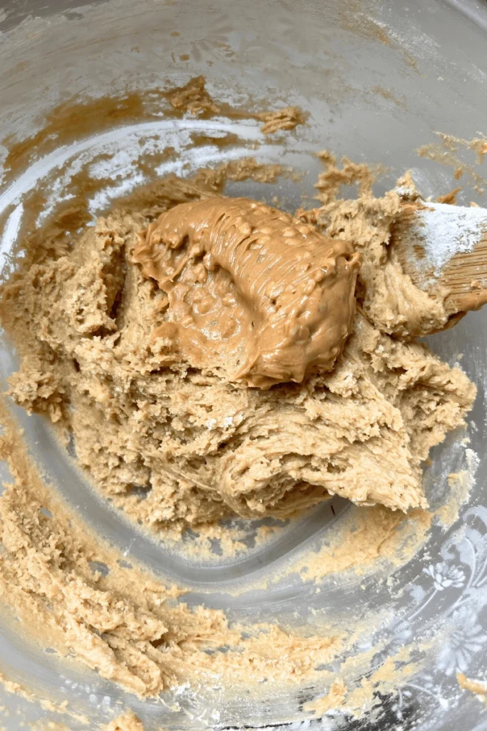 Chunky peanut butter in a Soft & Chewy Sourdough Peanut Butter Chocolate Chip Cookies batter. 