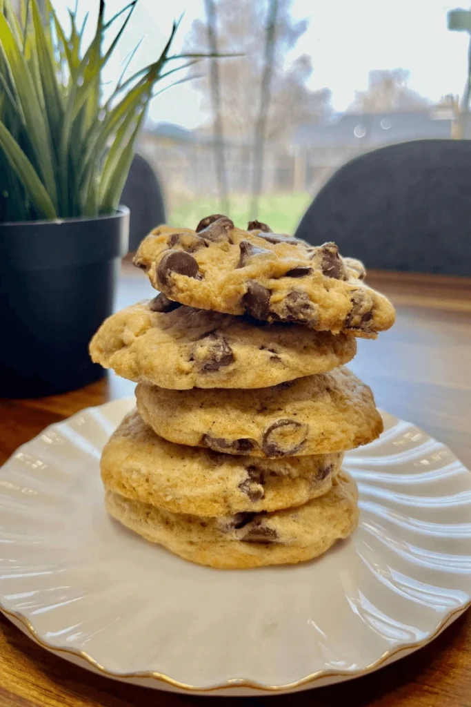 Sourdough Chocolate Chip Cookies stacked on a plate. 
