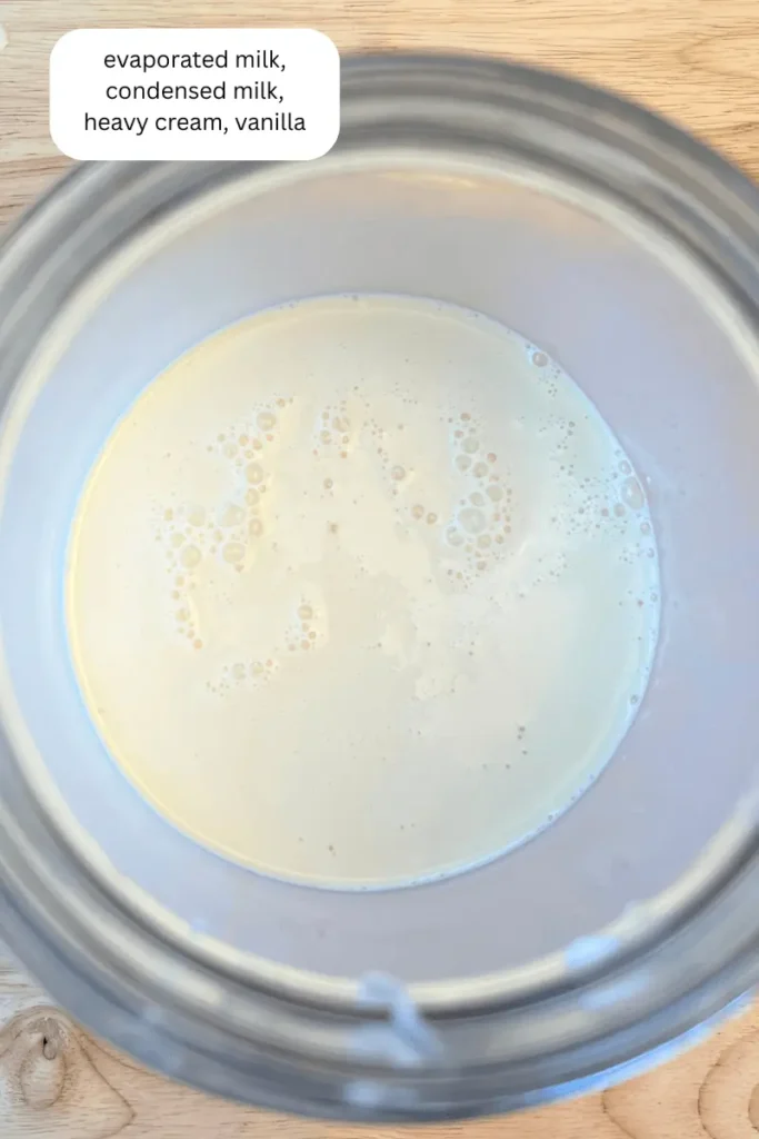Evaporated milk, condensed milk, heavy cream, and vanilla in a jar.
