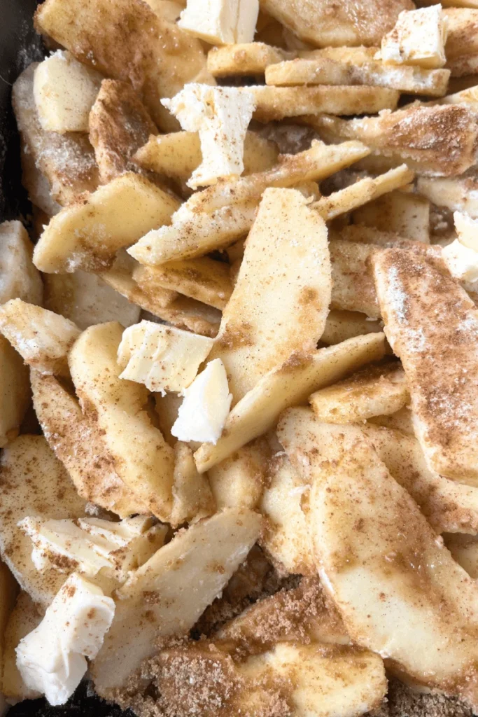 Apples with cinnamon and spices in a 9x13 pan. 