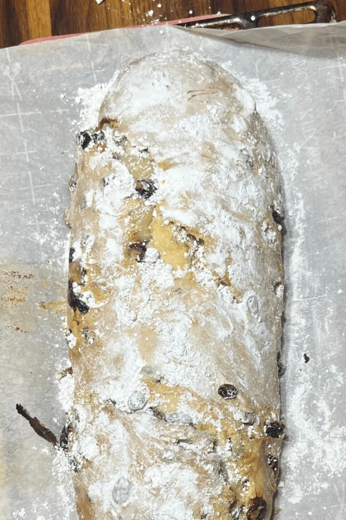 Sourdough stollen bread baked, buttered, and dusted in powdered sugar. 