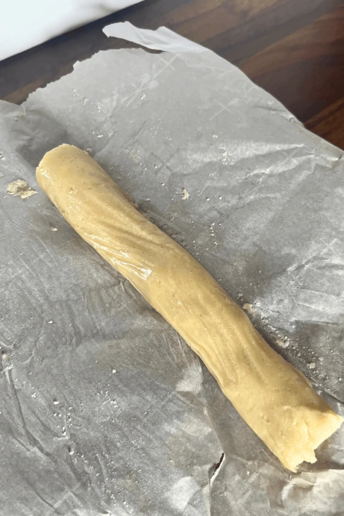 Homemade marzipan roll on a parchment paper. 