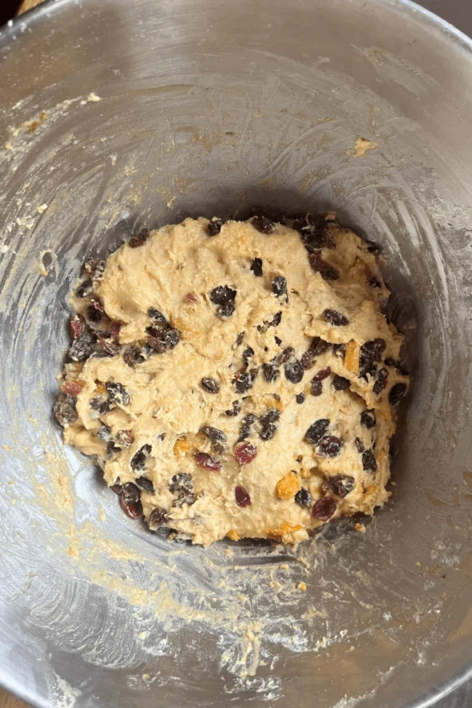 Sourdough stollen bread dough in a large mixing bowl.