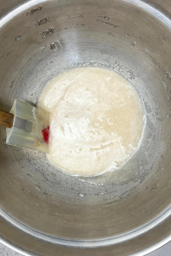 Mixing sugar, cinnamon, and salt in a small bowl for candied pecans coating.