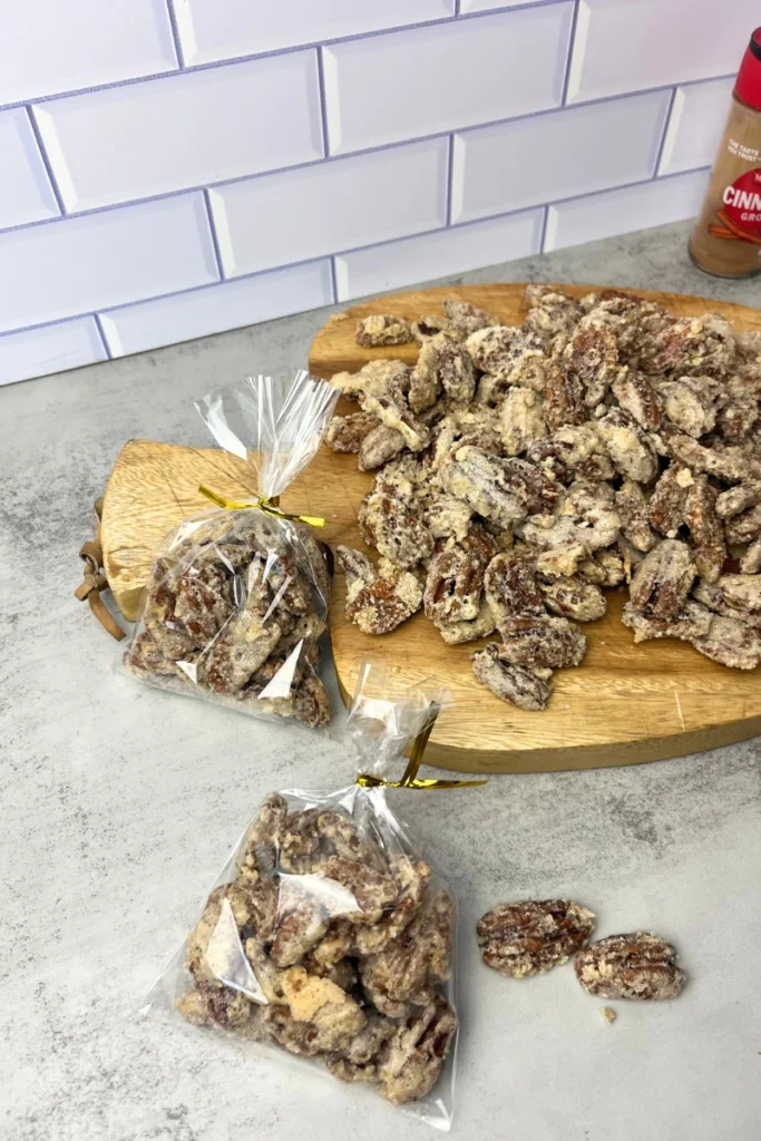 Egg white candied pecans cooling on a baking sheet, golden and crispy.