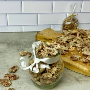 Candied pecans in small glass jars, perfect for gifting or holiday treats.