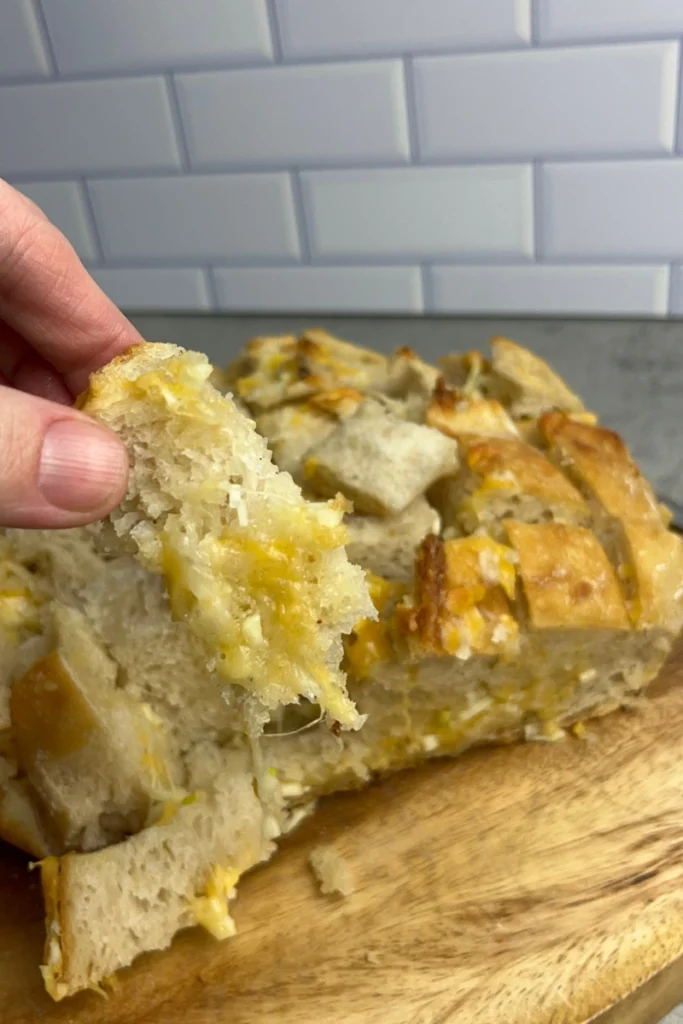 Sliced sourdough pull-apart bread filled with garlic butter and melted cheese.