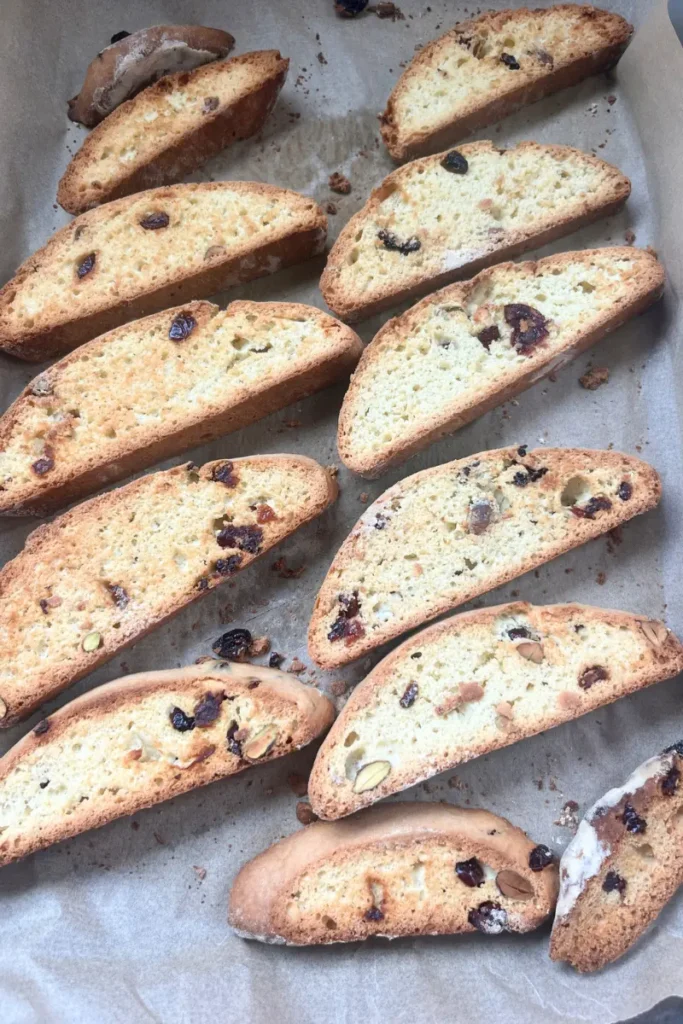 Fully baked sourdough biscotti laid out on a baking sheet after the second bake.