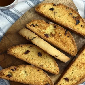 Homemade cranberry pistachio sourdough biscotti with dried cranberries and pistachios, served with tea.