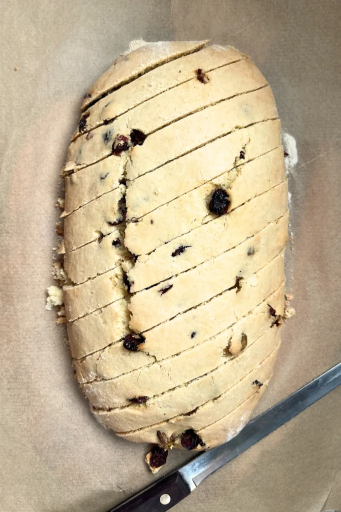 Sourdough biscotti log sliced diagonally into thick pieces before the second bake.