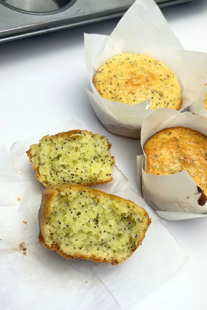 5 Close-up of a soft and fluffy sourdough lemon poppy seed muffin, showing a light, airy crumb with small poppy seeds and a moist, tender interior.